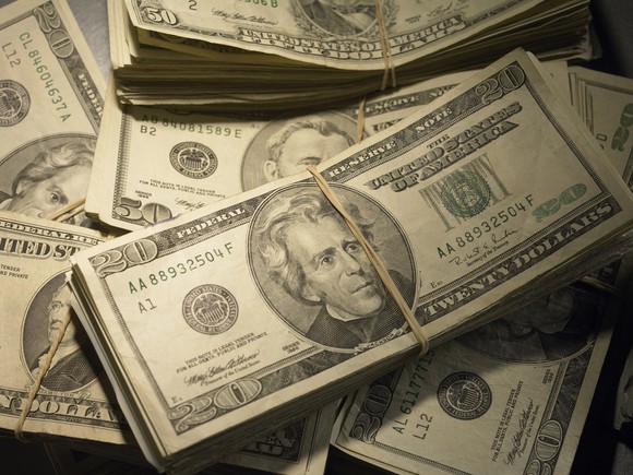Photo of bundles of old $20 and $50 bills