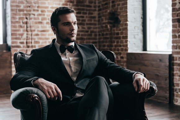 Man in suit sitting in chair