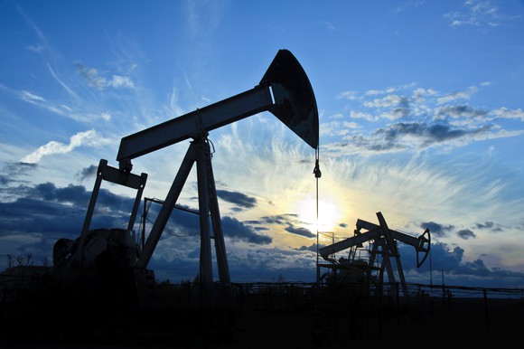 A group of oil pumps at dusk.