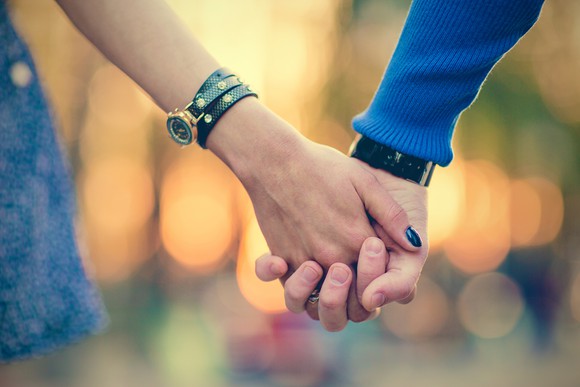 young couple holding hands