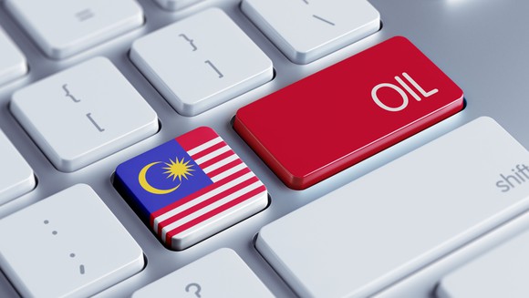 A keyboard with a Malaysian flag key next to an oil key.