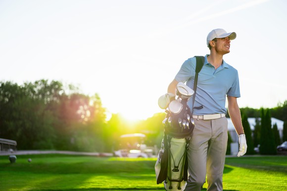 Man carrying golf clubs