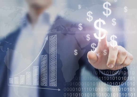 Man pointing to dollar signs.