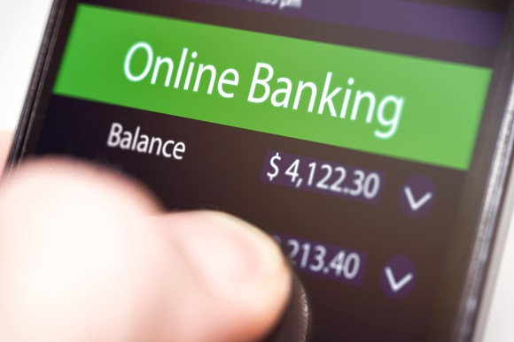 Smartphone with online banking app open on screen.