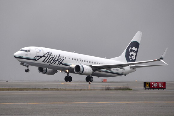 An Alaska Air plane taking off.