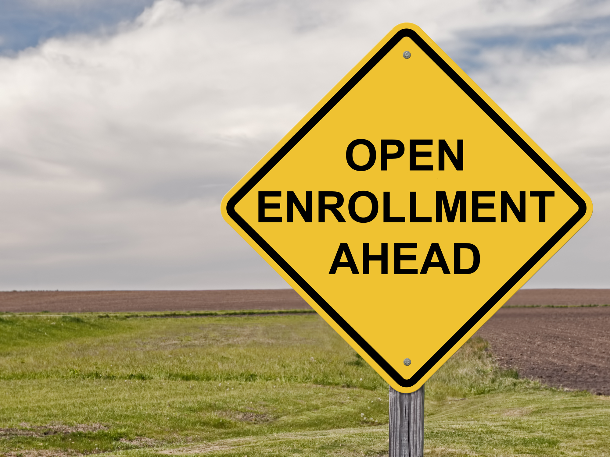 A road sign reads open enrollment ahead.