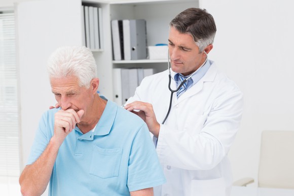 Doctor examining senior male patient
