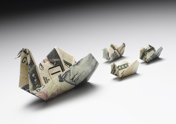 Dollar bills folded into ducklings following their mother.