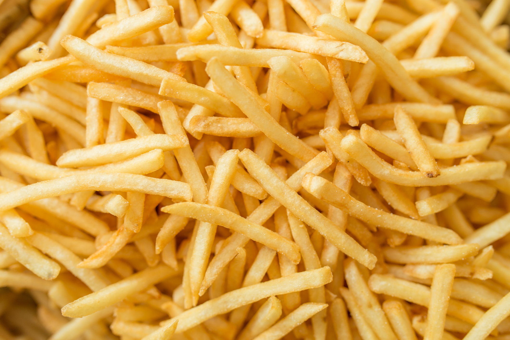A close-up shot of a plate full of French fries.