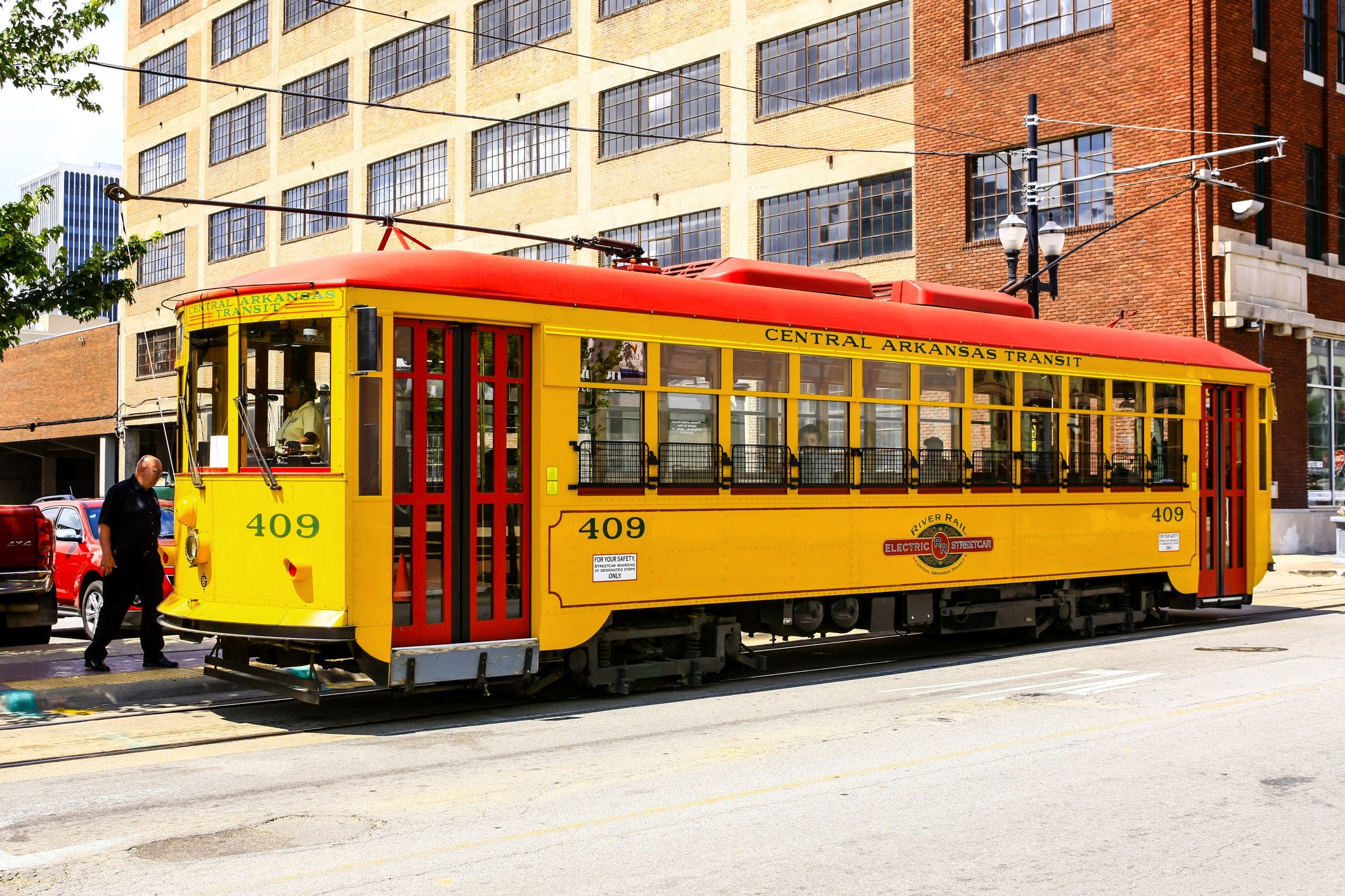Bright yellow vintage city streetcars in downtown Little Rock Arkansas