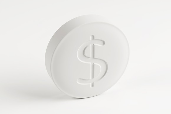 A generic drug tablet stamped with a dollar sign.