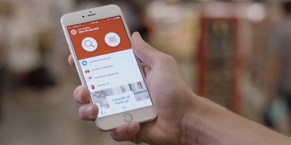 A hand holds a phine showing the Target app.