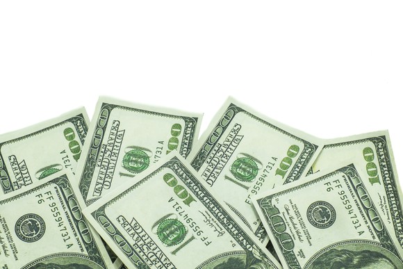About 7 hundred dollar bills isolated on white background