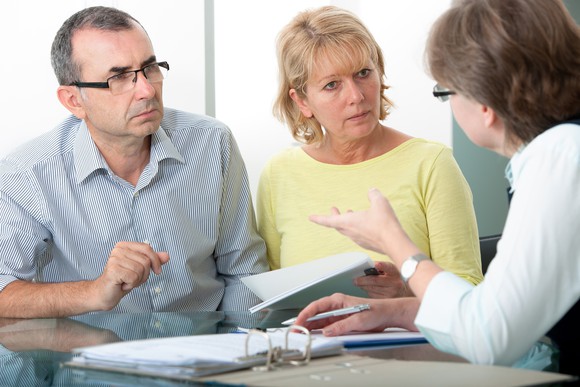 Couple speaking to another woman