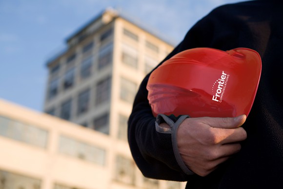 Someone holding a Frontier hardhat.