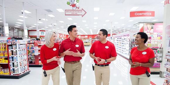 A group of Target employees smile at each other