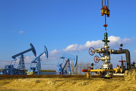 Three blue oil pumps.