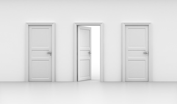 Three white doors with one in the middle opened