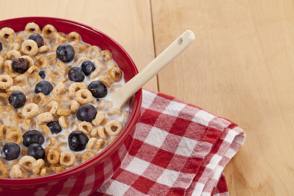 A bowl of cereal on a table with a napkin.