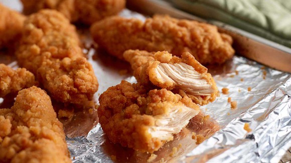 Tyson breaded chicken strips on tin foil