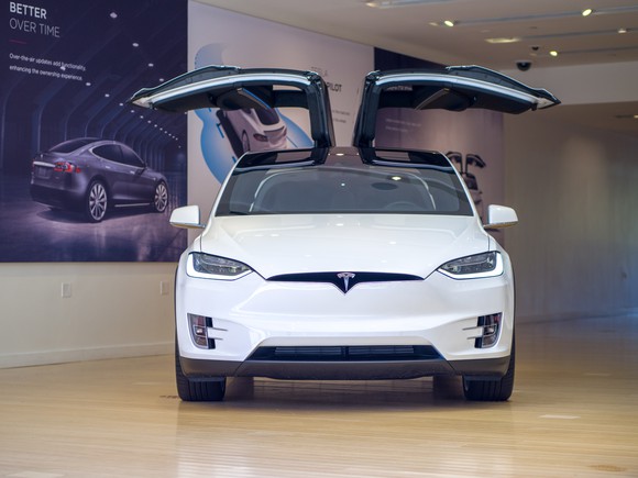 A white Model X in a Tesla store.