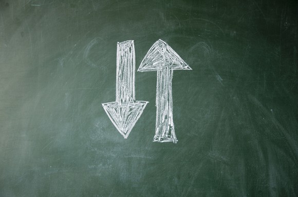 Two arrows drawn on a chalkboard. One is pointing up and the other is pointing down.