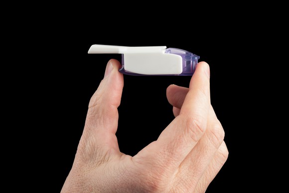 A hand holding Afrezza.