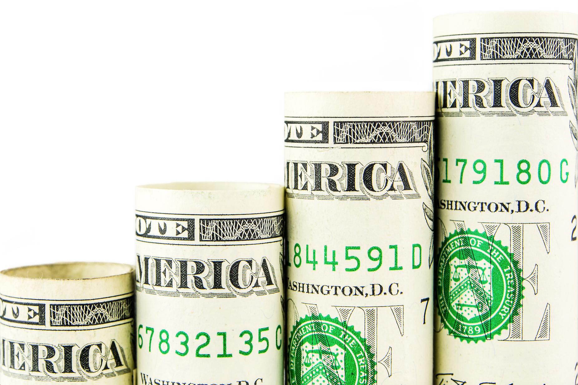 Rolled up dollar bills arranged in shape of an upward sloping chart.