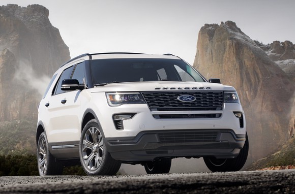 A while 2018 Ford Explorer in a rocky landscape.