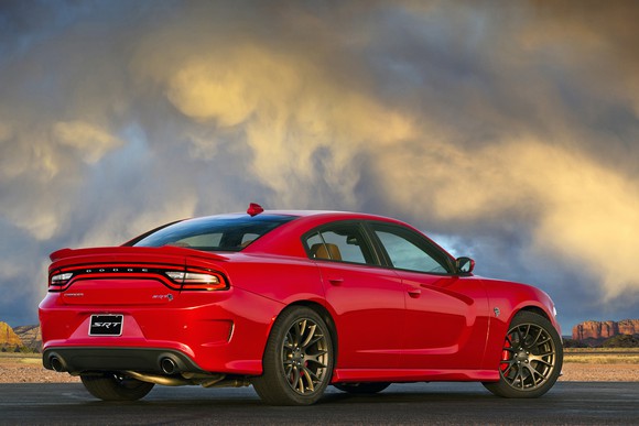 A red 2017 Dodge Charger SRT Hellcat, a full-size sedan, parked on a desert road.