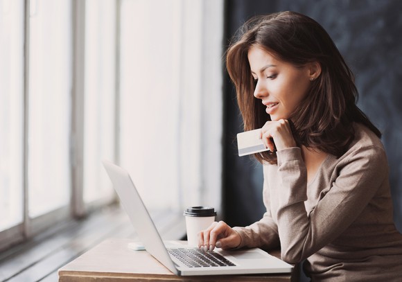 A woman shops online with a credit card.