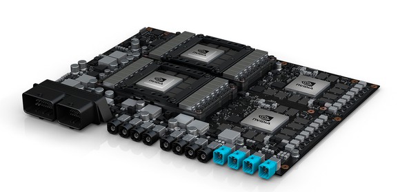 NVIDIA's Drive PX Pegasus, a circuit board with four big processor chips and a slew of plugs