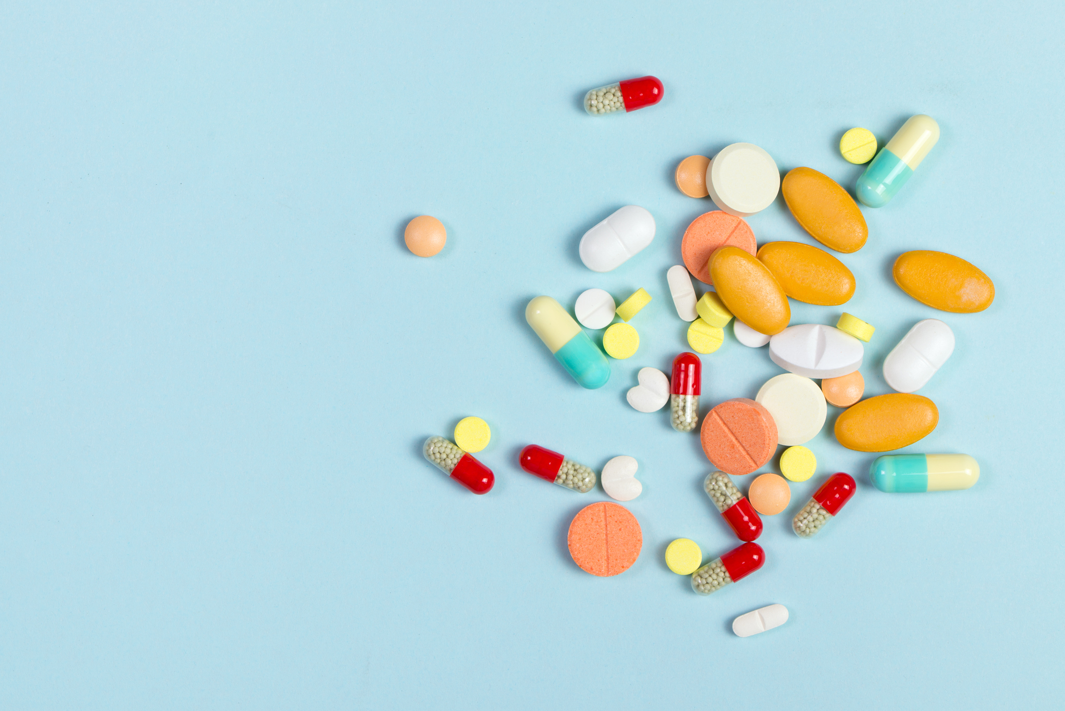Colorful pills on a blue background.