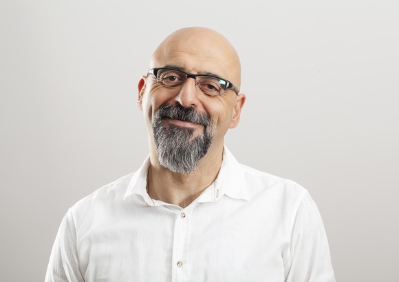 Smiling bald man with glasses and beard