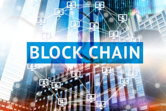 Reads "Blockchain" across the picture with computer graphics in background.