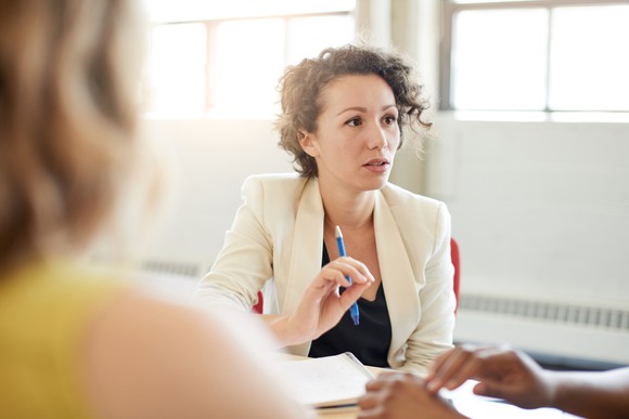 Professional woman facing others