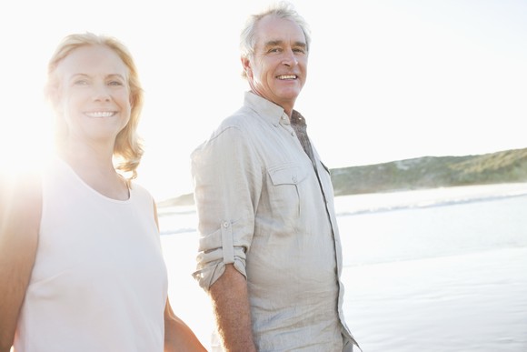 Retired couple walking on the beach