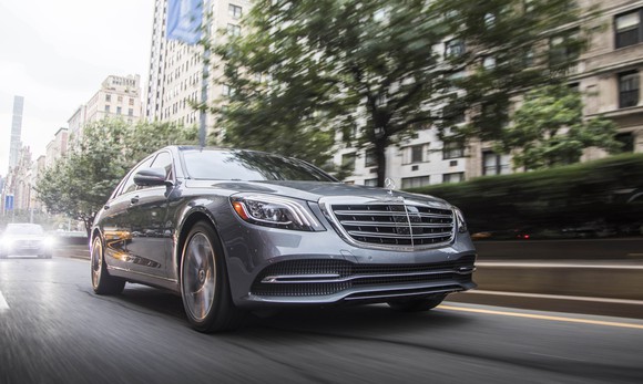 A silver 2018 Mercedes-Benz S450, a big four-door luxury sedan, on a city street.
