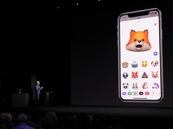 Apple's software chief on stage demonstrating the face-tracking capabilities of the new iPhone X.