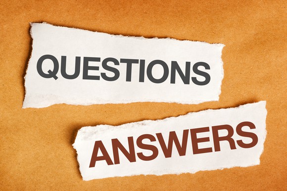 two torn pieces of paper, with "questions" printed on one and "answers" printed on the other