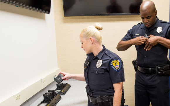 Police officers putting on Axon body cameras