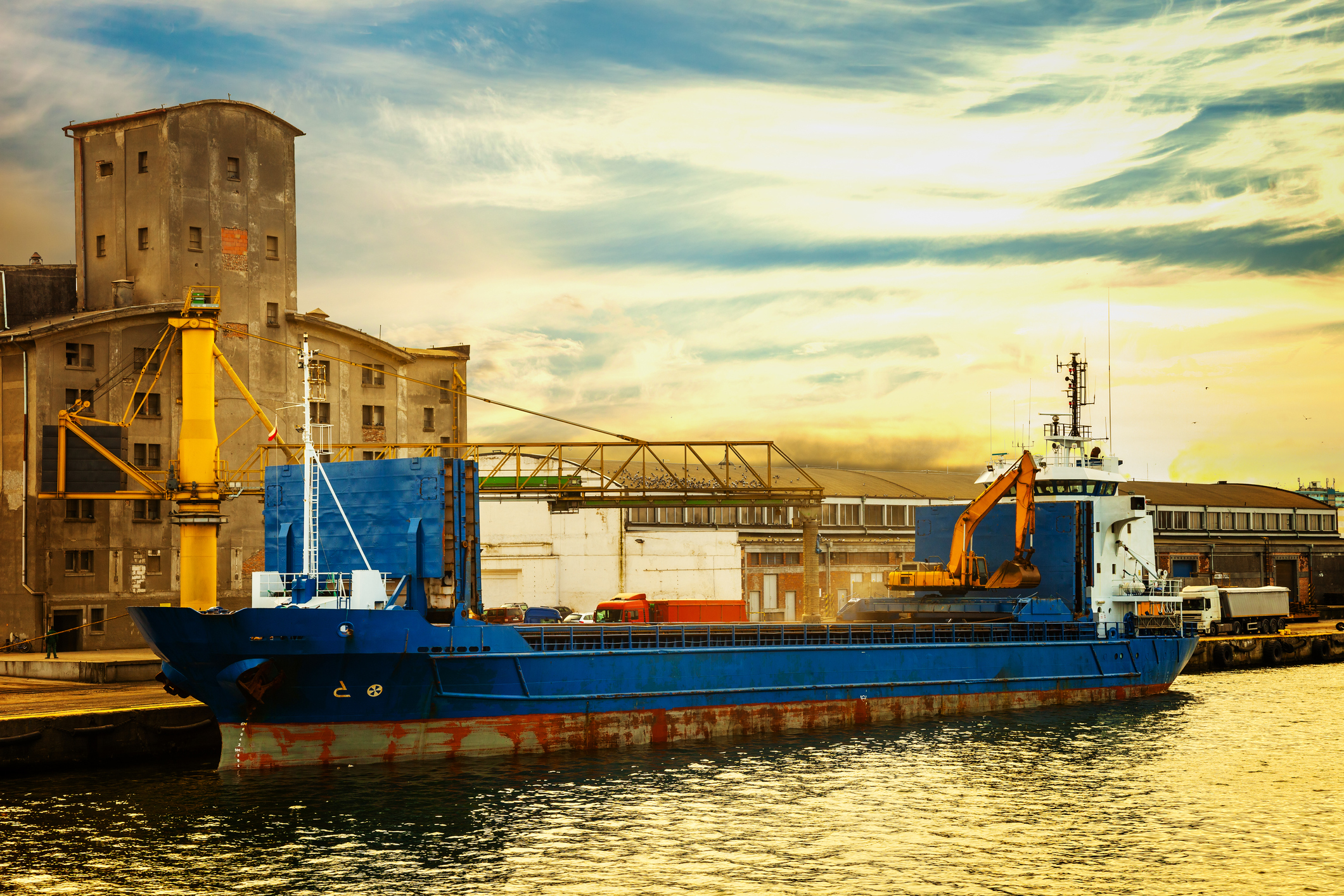A grain ship loading at a port.