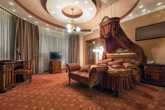 The interior of a classic style luxury hotel room.