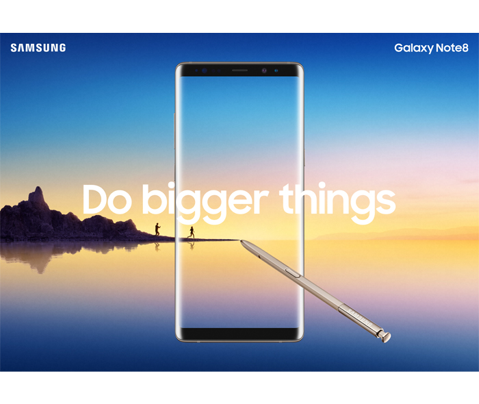 Samsung Galaxy Note8 advertisement featuring the phone overlaid with the text "Do Bigger Things" on a background featuring a landscape picture of people hiking on a jetty