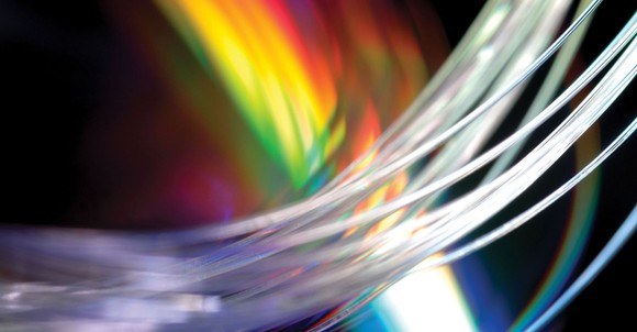 Mutli-colored light shining through Corning optical fiber