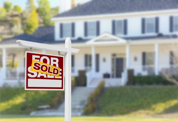House with a "sold" sign out front