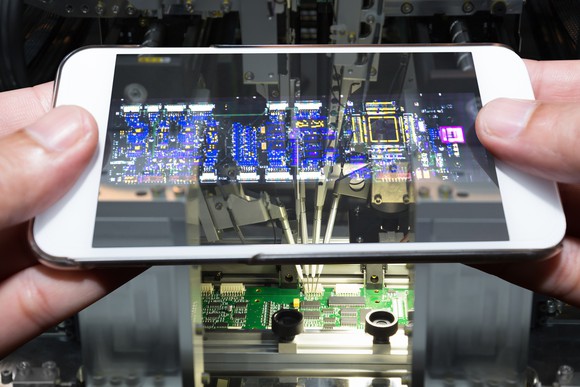Smartphone looking at a circuit board.