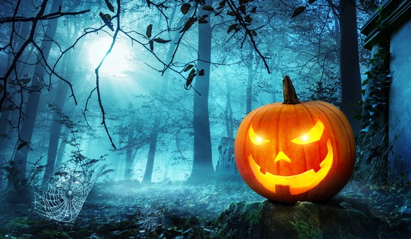Jack o' lantern in woods at night