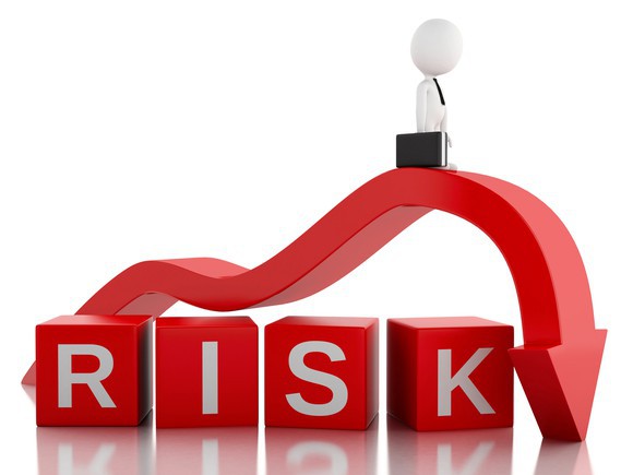 A red arrow points down over cubes spelling the word risk.