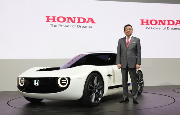 Hachigo is standing next to the Honda Sports EV Concept, a futuristic-looking curvy white coupe, on Honda's show stand at the Tokyo Motor Show on October 25, 2017.